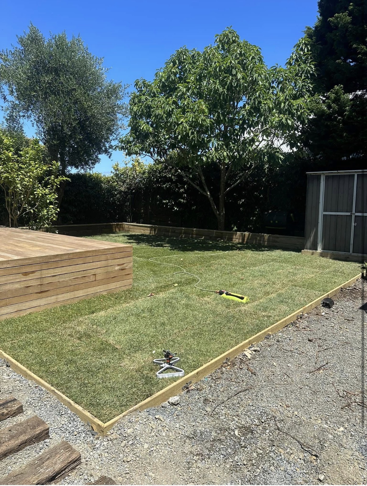 Timber deck with lawn, retaining wall borders and established garden — Element Landscaping Waikato