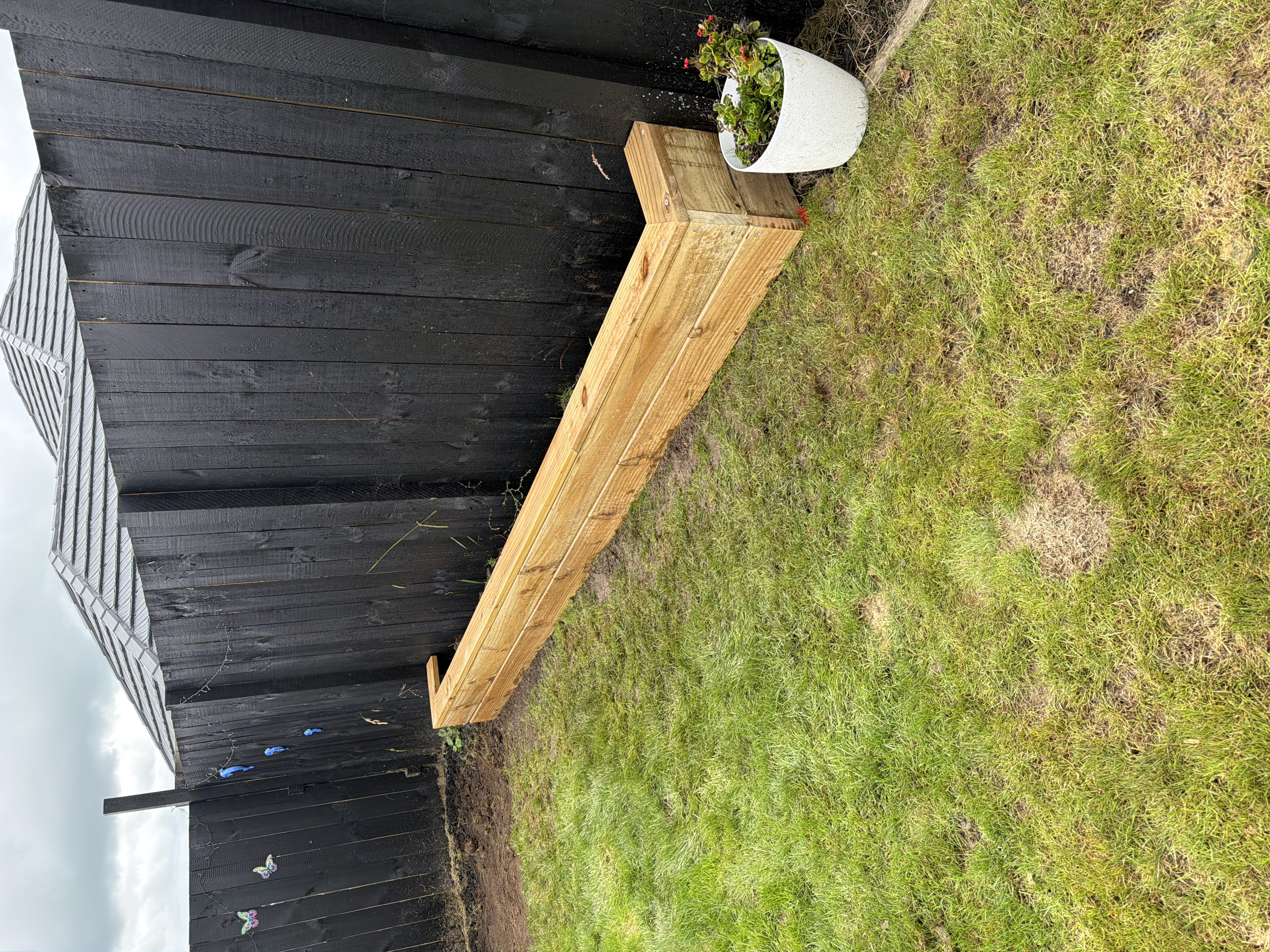 Timber planter box along boundary fence — Element Landscaping Waikato