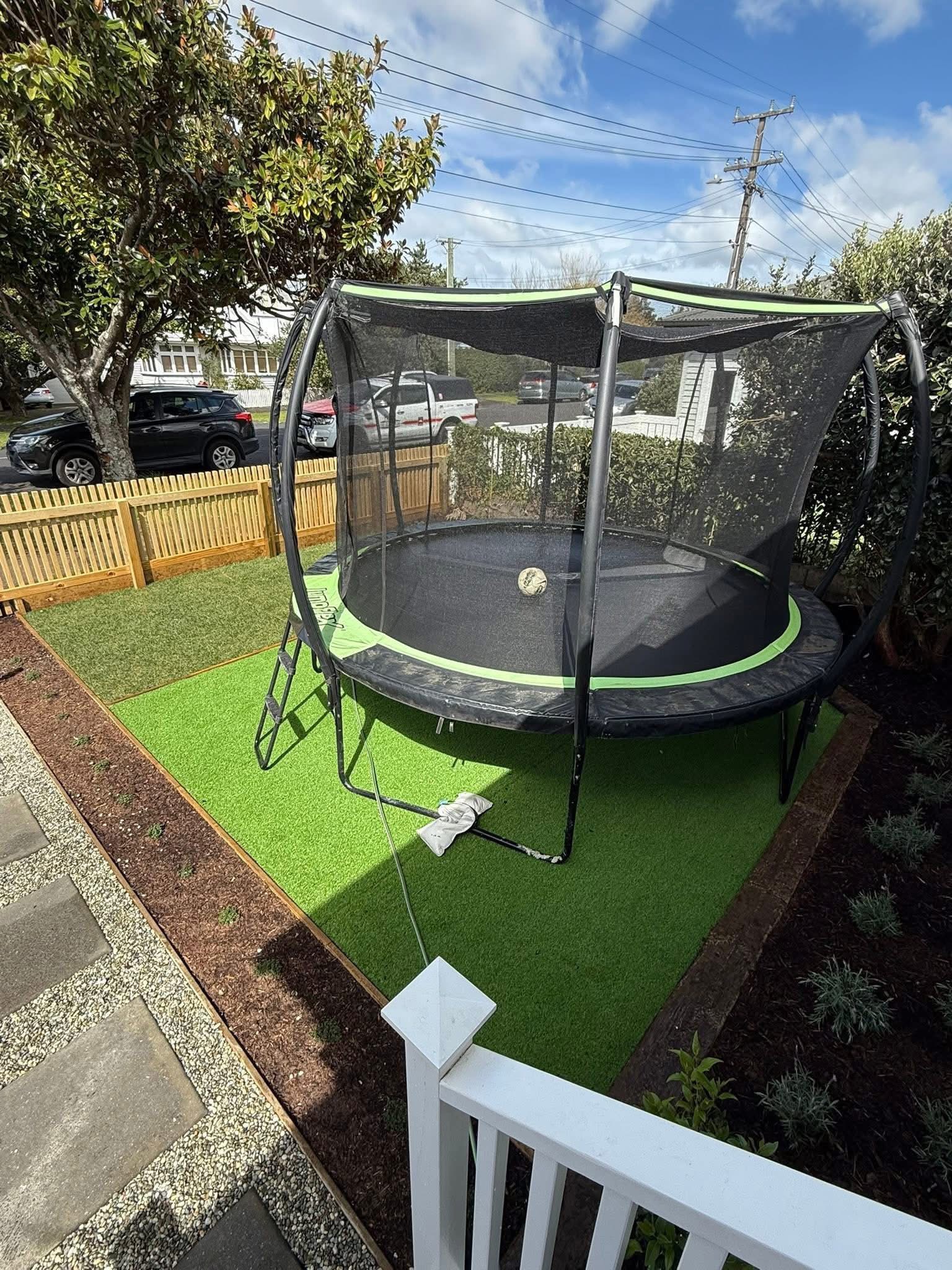 Artificial lawn with timber fencing and garden border landscaping — Element Landscaping Waikato
